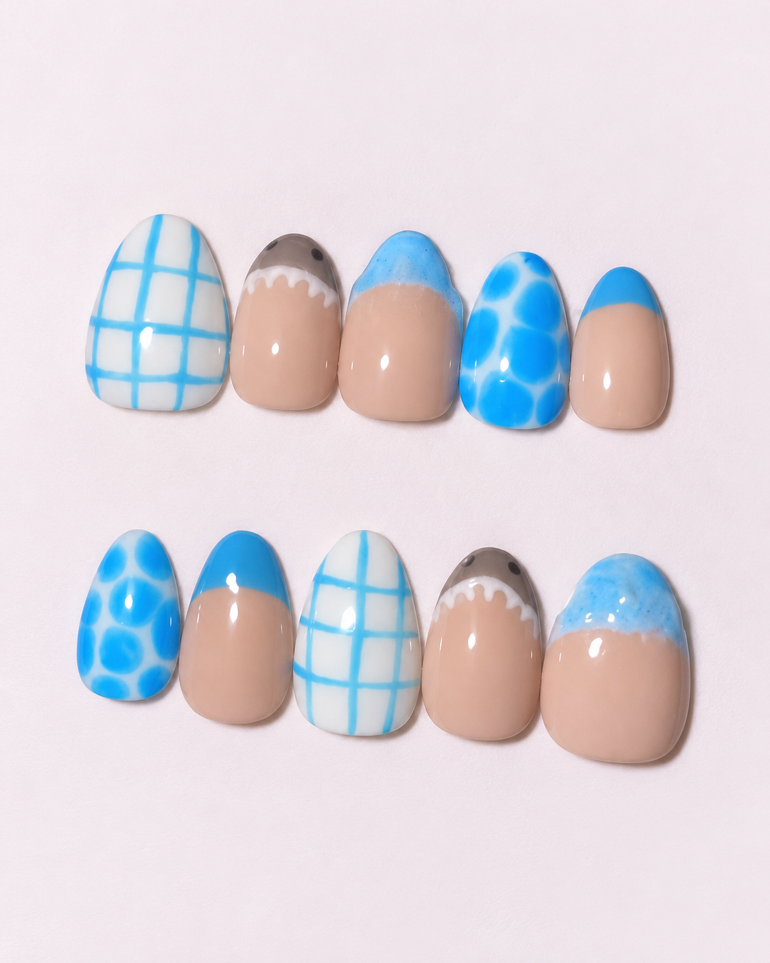 Blue and nude nails with checkered and ocean-inspired accents