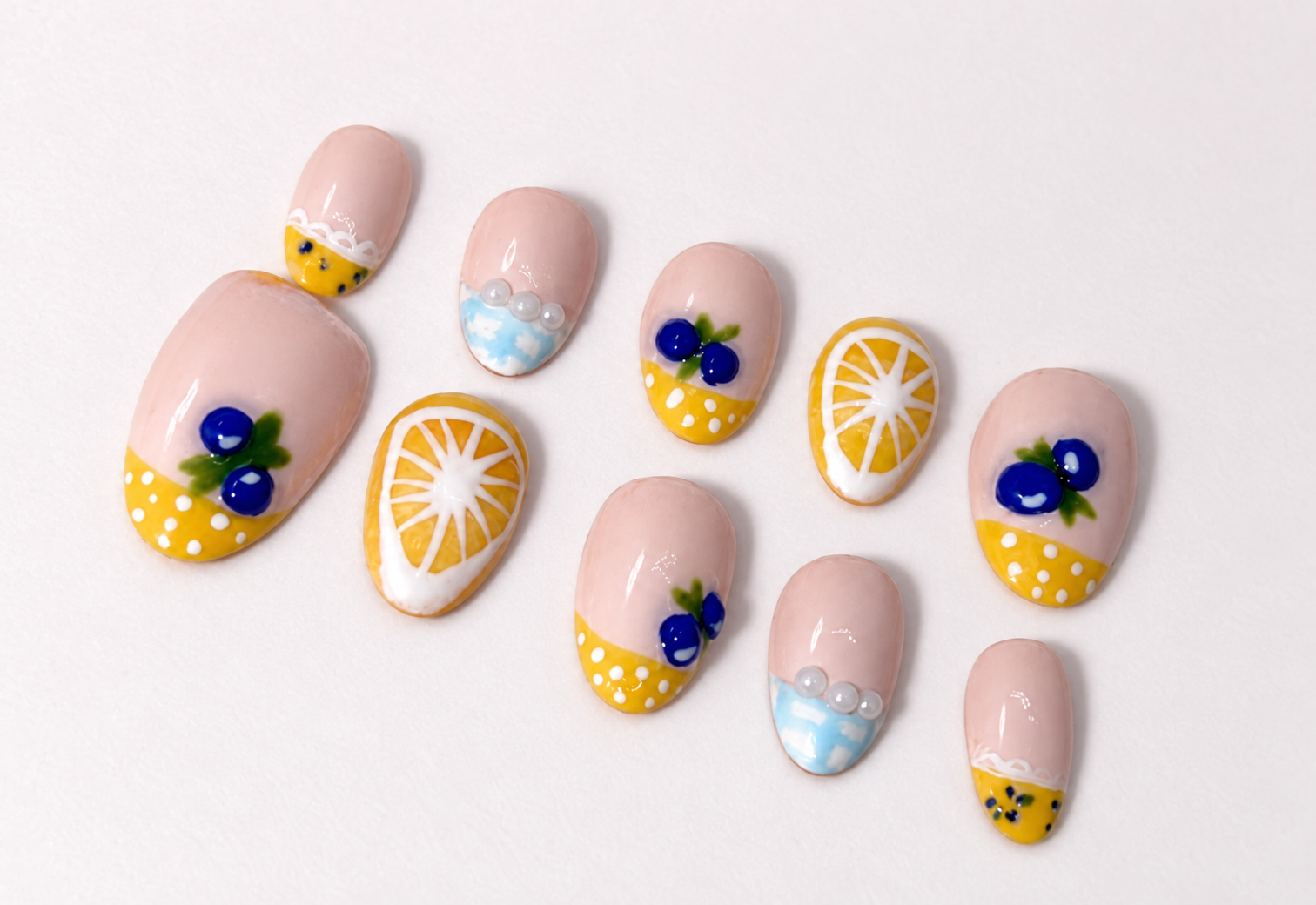 Handmade lemon and blueberry nail art with yellow French tips