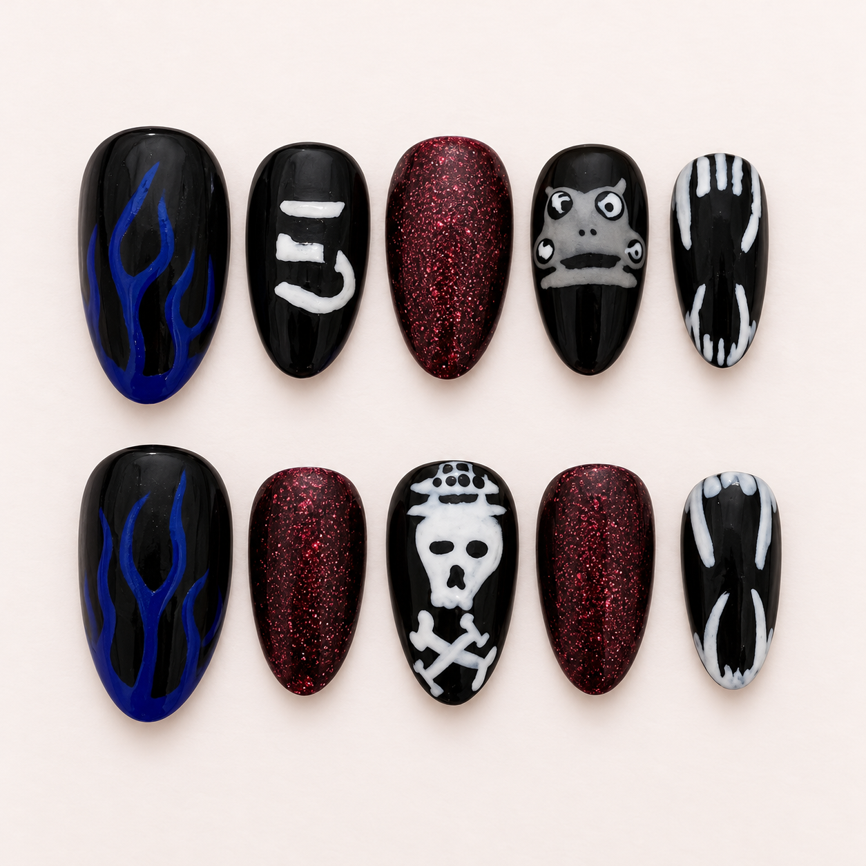 Black and burgundy concert nails with skulls and band-inspired artwork