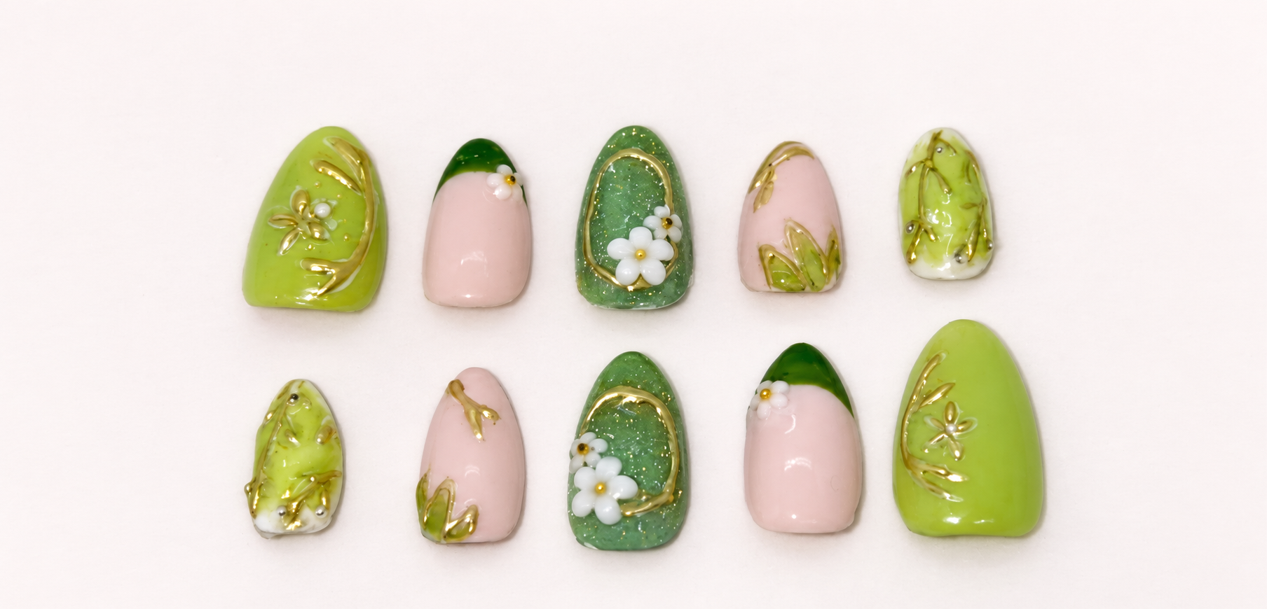 Green and nude press-on nails with white flowers and gold botanical details
