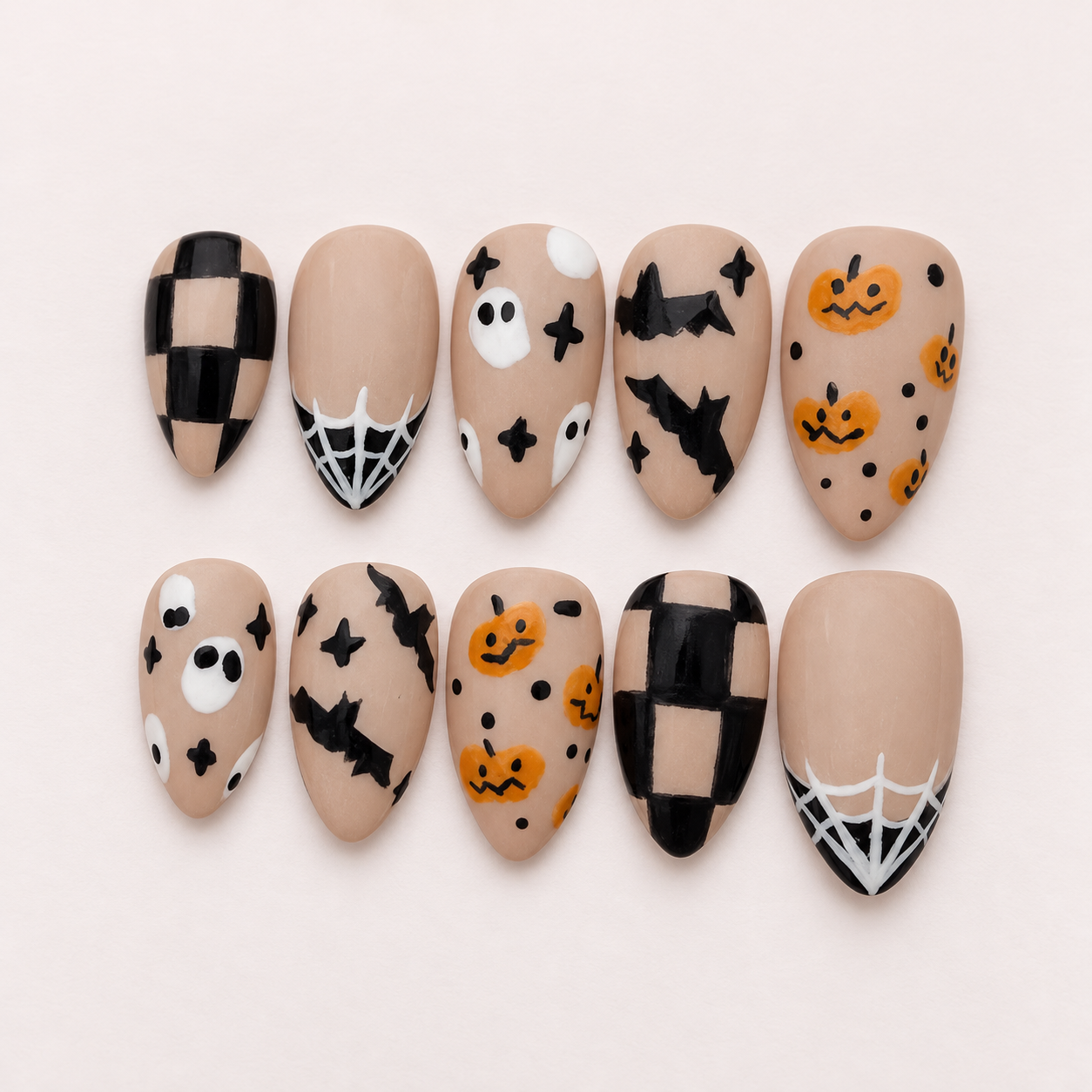 Nude Halloween nails with ghosts, bats, pumpkins, spiderwebs and checkerboard accents