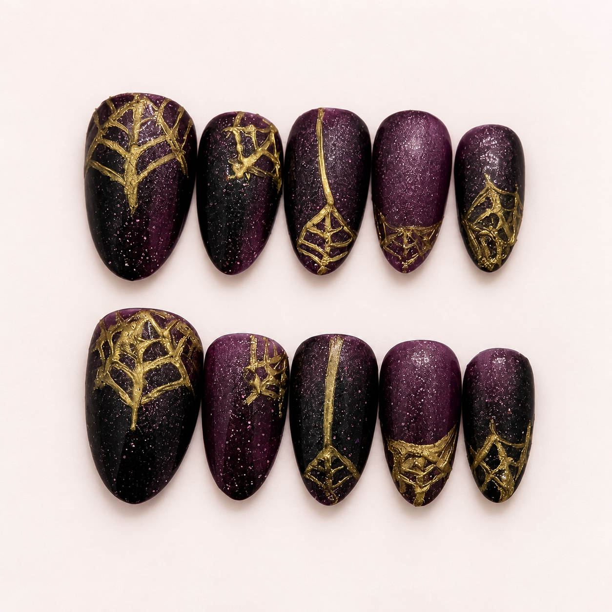 Purple and black nails with gold spiderwebs