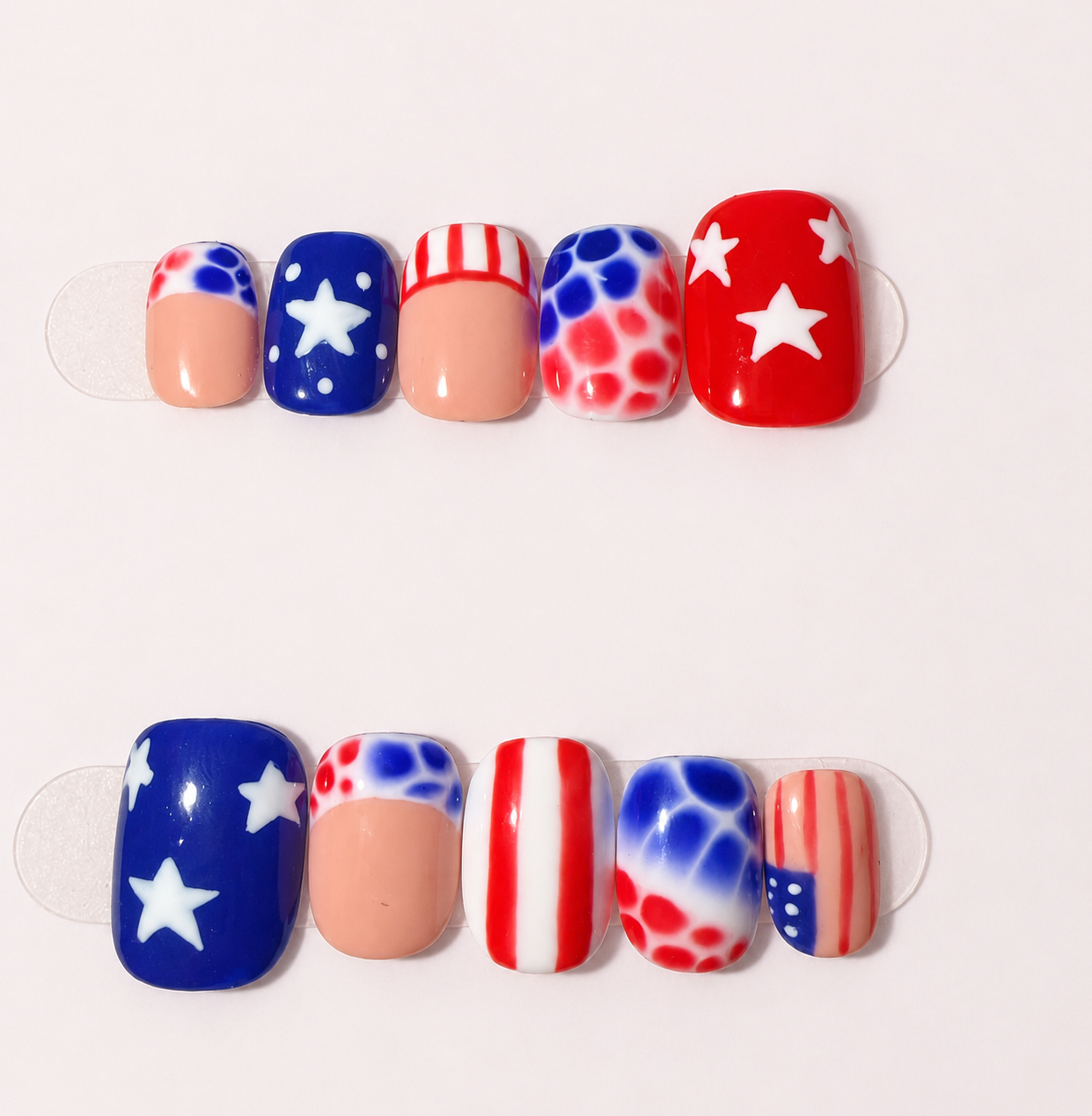 Red, white, and blue nails decorated with stars and stripes